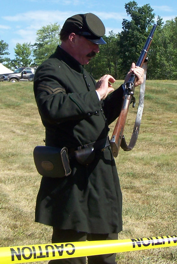 Phil Winger demos the Sharps rifle behind the sturdy barrier.3775